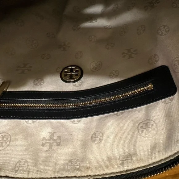 Tory Burch used handbag. About 15” wide and 13 “ tall. This bag is not new.